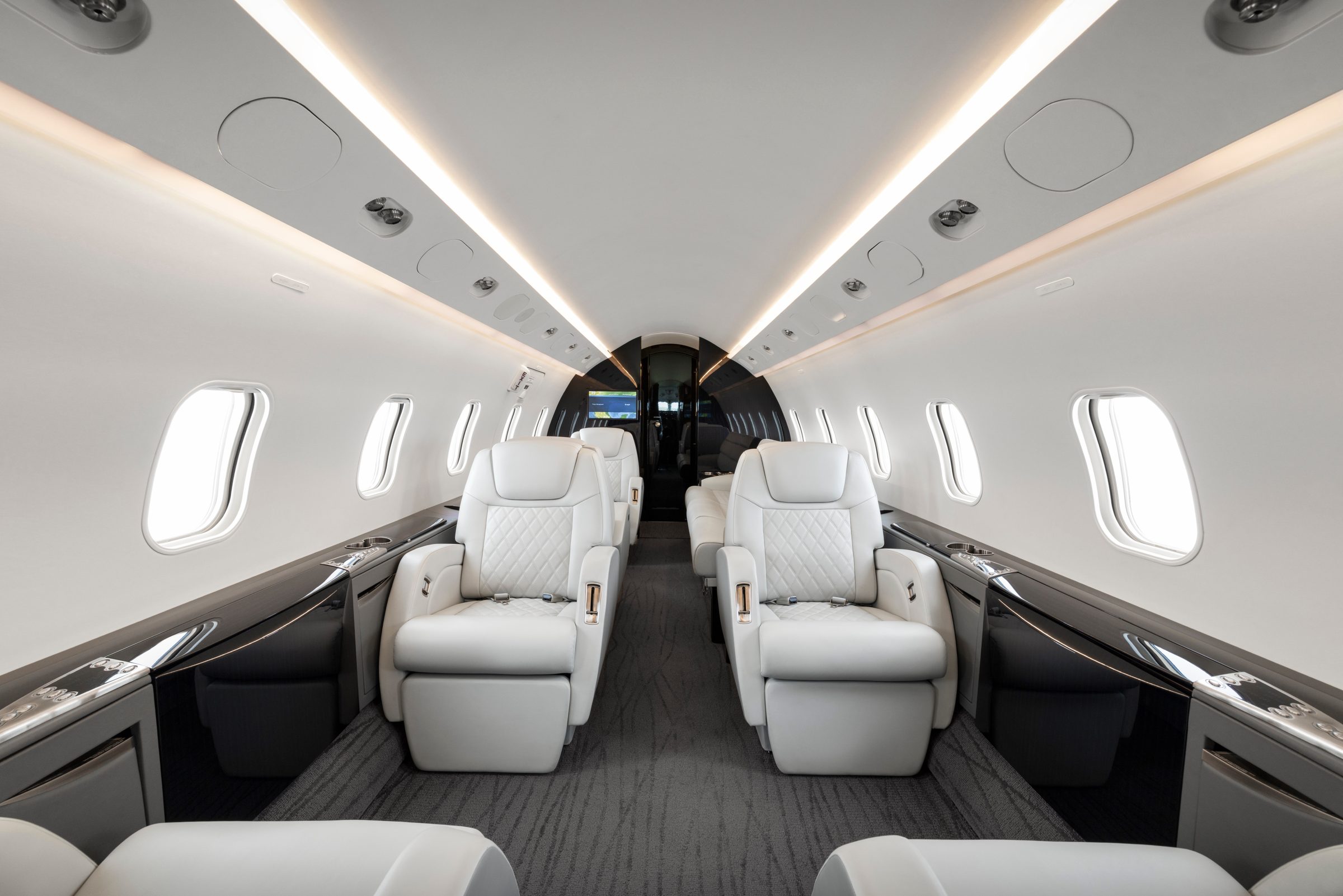 Forward cabin with four ivory leather club seats and gloss black cabinetry